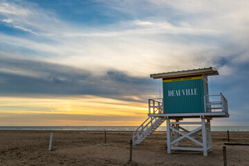 Wall Mural - Retro lifeguard station tower on the beach of Deauville at sunset in Normandy, France