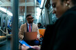 © bernardbodo - Businessman working on laptop on subway commuting home