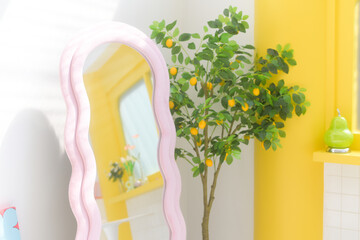 Poster - stylish mirror reflects vibrant room with lemon tree and bright decor