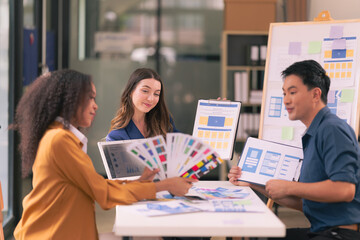 Wall Mural - ux/ui design team discuss and brainstorm layouts for websites and mobile app prototypes in website a