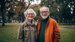 © Natalia Klenova - Elderly couple smiling in autumn park.
