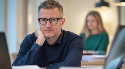 Aufkleber - Middle-aged man concentrating on work in a modern office environment during the day