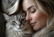 © ANUAR - A young woman with blonde hair enjoying a peaceful moment cuddling a fluffy gray cat with beautiful green eyes in a cozy indoor setting