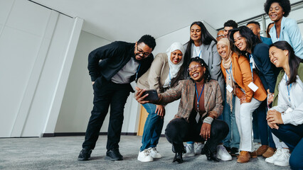 Wall Mural - diverse group of colleagues taking a selfie during a team bonding session at the office