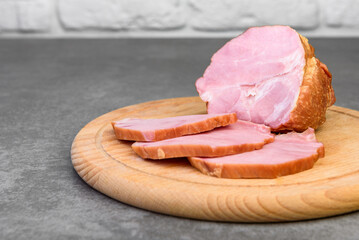 Wall Mural - Sliced cold smoked meat on gray background.