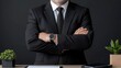 © BROPRADANA - Confident businessman arms crossed, office desk