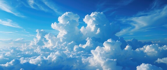 Wall Mural - Vibrant blue sky adorned with fluffy white clouds creating a serene and tranquil atmosphere for nature and travel themes