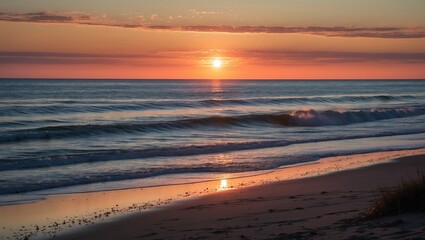 Wall Mural - serene coastal sunset over gentle waves reflecting golden light on sandy beach