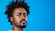 © Kateryna - Confused Man Portrait with Curly Hair against Blue Background