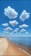 Canvas Print - Bright Blue Sky with Fluffy White Clouds Over Sandy Beach and Calm Ocean