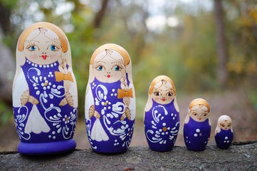 Wall Mural - Beautiful wooden nesting dolls stand in a row. Traditional dolls.