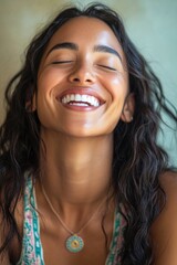 Wall Mural - A woman smiling with her eyes closed, conveying happiness and contentment