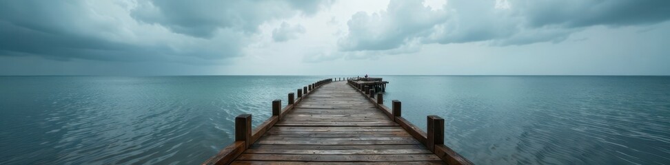  Rustic wooden pier stretches towards a dramatic, overcast sky above the grey sea , outdoor, sea