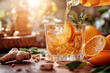 © Iryna - Refreshing citrus cocktail with ice, orange slices, and fresh herbs being poured into a glass surrounded by ginger and sunlight