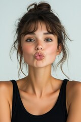 Wall Mural - funny portrait of young woman with kissing lips on white background