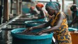 © Tetiana - African Female Workers Sorting Coffee Beans At Washing Station: Hardworking Women Undertaking The Task Of Sorting Coffee Beans In Africa.
