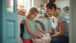 © natakot - A smiling mother and her young daughter share a delightful moment as they load freshly washed clothes into a washing machine. The warm, sunlit laundry room radiates a cozy atmosphere, highlighting the