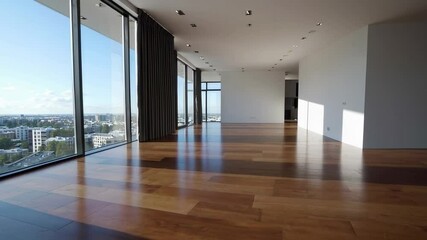 Fototapete - Sunlight moves across the hardwood floor of an empty, spacious, and minimalist apartment with large windows offering a city view, captured in a slow motion sequence