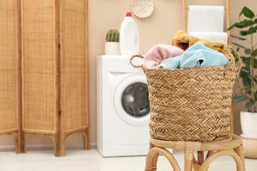 Wall Mural - Wicker basket full of laundry on chair in bathroom