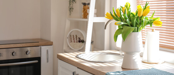 Wall Mural - Beautiful vase of yellow tulips on kitchen counter