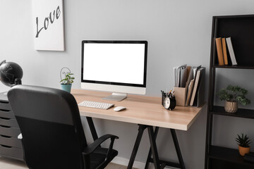 Wall Mural - blank computer monitor with alarm clock on table in office