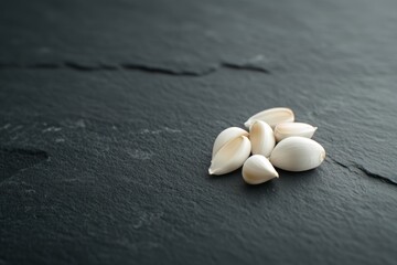 Wall Mural - Pile of white seeds on a black surface