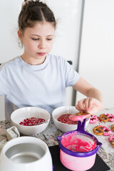 Wall Mural - Young Chef Prepares Chocolate-Covered Treats in Sunny Kitchen