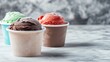 © pinporn manosri - Frozen ice cream tubs with frost-covered lids, arranged on a white marble background with a spacious copy space.