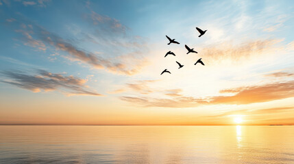 Sticker - flock of birds flying across serene orange sunset over calm water