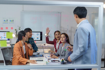 Wall Mural - asian business team brainstorming and discussing new project in modern office