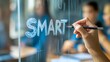 © Atmospheric stock - Hand writing smart on transparent board in education setting with blurred students background