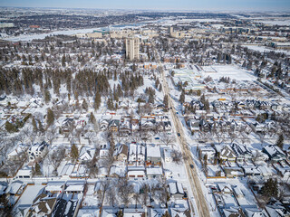 Wall Mural - Snowy cityscape with a large building in the background