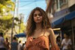 © MediaRaw - A woman with long brown hair stands in front of a blue canopy