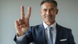 © Muneer - A businessman pointing and showing a stop gesture with a confident smile and hand signs