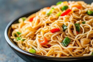 Wall Mural - Delicious vegetable noodles, close-up, dark bowl, kitchen setting, food blog