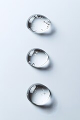 Sticker - White background with three drops of water on the surface