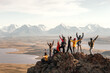 © cppzone - Large group of tourists diverse people hikers are standing at mountain top at winner poses with open raised arms and enjoys achievement