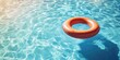 © Gular - Bright blue pool water with sunlight reflections and a textured orange lifebuoy floating in the center, creating a serene summer atmosphere.