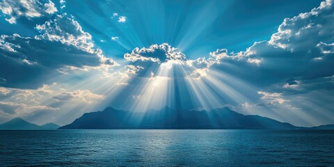 Aufkleber - Radiant beams of sunlight pierce through dramatic blue clouds over a serene sea with distant mountains creating a breathtaking natural background.