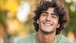 © InspirationDesign - Young man with curly hair laughing outdoors in autumn setting. Great for lifestyle content, authentic portraits, and seasonal campaigns