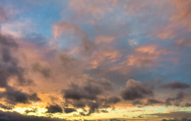 Wall Mural - a beautiful sky tinted by the sun leaving vibrant shades of gold, pink, blue and multicolored. cloud