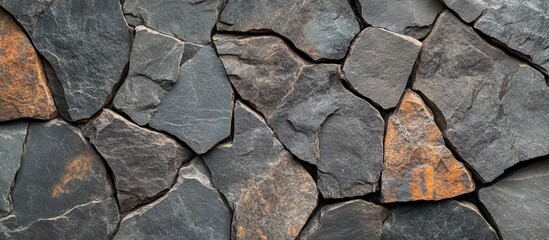 Wall Mural - textured background of cracked dark stones in various shades of gray and brown stone suitable for na