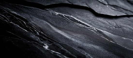 Wall Mural - textured black stone surface with abstract patterns and subtle lighting effects for background or de
