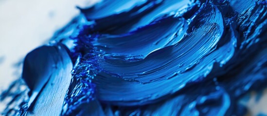 Poster - Vibrant blue paint texture showcasing dynamic brushstrokes on a canvas surface ideal for artistic backgrounds and creative projects