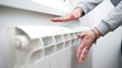 © astrosystem - Woman heating on a chilly winter day, energy and gas crisis, cold room, heating problems.