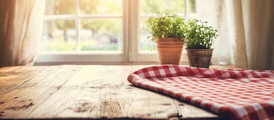 Aufkleber - Checkered tablecloth on rustic wooden kitchen table with plants in pots and soft sunlight creating a warm cozy atmosphere
