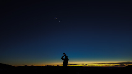 Wall Mural - amateur astronomer looking at the evening skies, observing planets, stars, moon and other celestial 