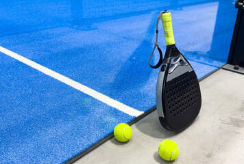 Wall Mural - padel racket on a padel court with a ball