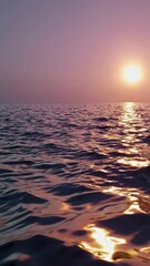 Aufkleber - A surreal landscape with flowing, silky waves reflecting warm sunset light.