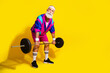 © deagreez - Full length photo banner of sportive cheerful old man lift barbell dressed stylish retro sportswear isolated on yellow color background